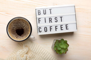 a lightbox with a sign next to a cup of coffee